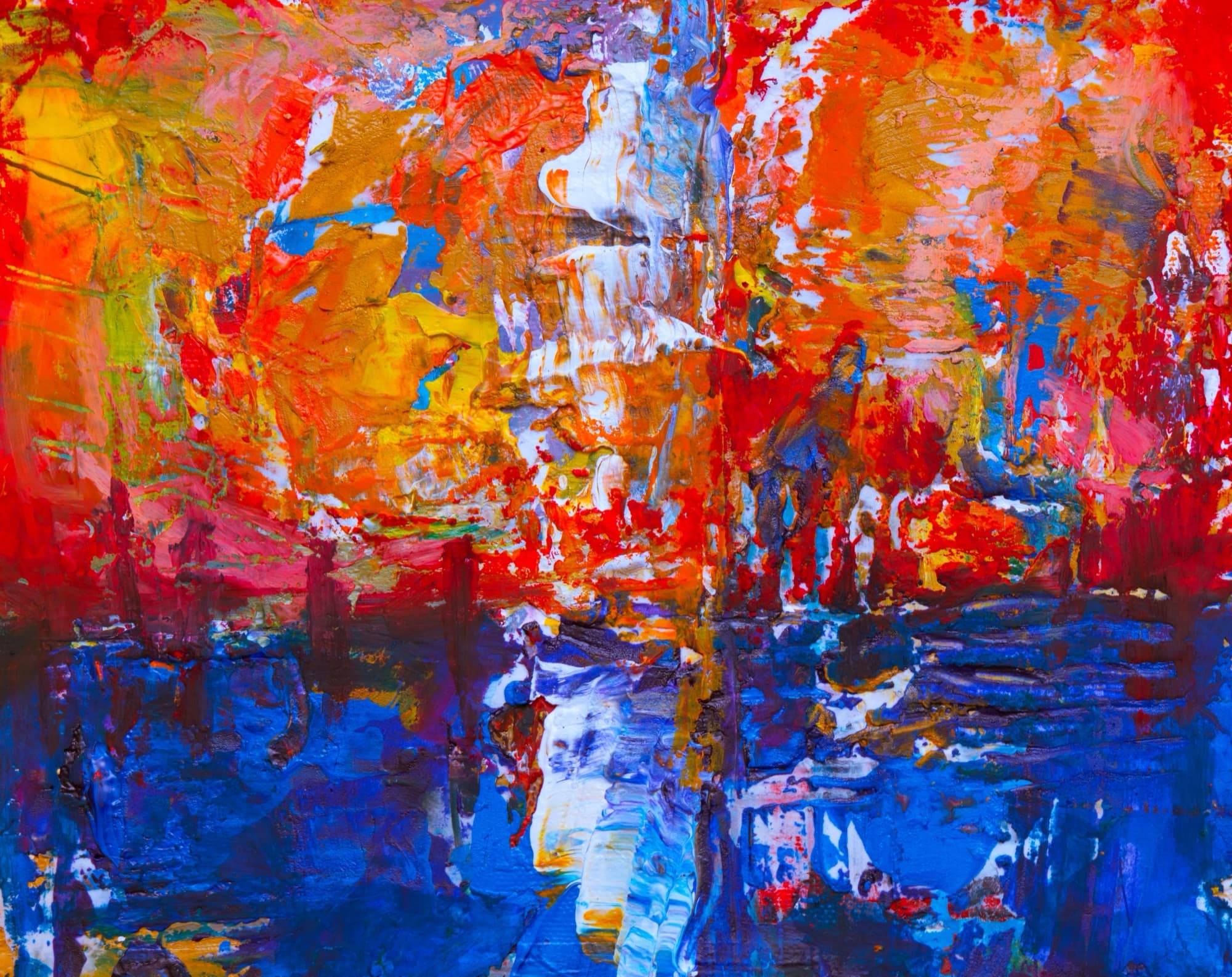 Abstract acrylic painting in red over deep blue